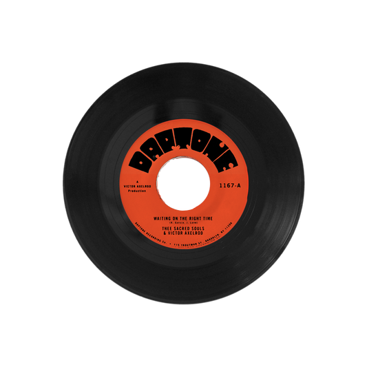 Black vinyl record with a red label on a white background